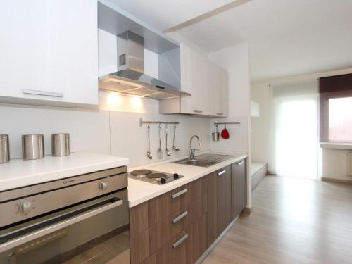 a large kitchen with a sink and a stove at Apartment Am Birkenhain-30 by Interhome in Seefeld in Tirol