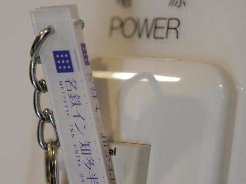 a key chain attached to a toilet in a bathroom at Meitetsu Inn Chita Handa Ekimae in Handa