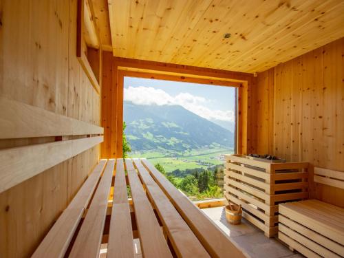 a wooden sauna with a view of a mountain at Apartment Brandegg Top 2 by Interhome in Fügenberg