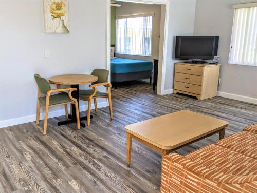 a living room with a couch and a table at Johns Pass Beach Motel in St Pete Beach