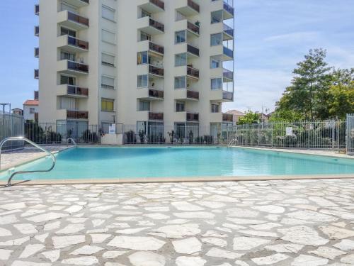 a swimming pool in front of a building at Apartment Port Arcachon-1 by Interhome in Arcachon