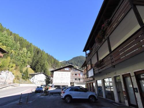 a white car parked in a parking lot next to a building at Apartment Cesa Lucilla by Interhome in Canazei