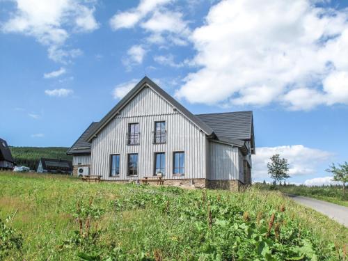 a white house on a hill in a field at Apartment Na Pomezkách by Interhome in Horní Malá Úpa