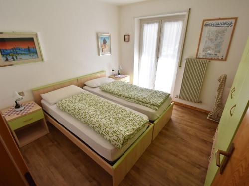 a bedroom with two beds and a window at Apartment Cesa Lucilla by Interhome in Canazei