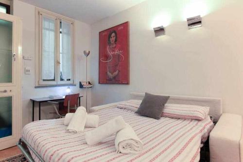 a bedroom with a bed with towels on it at Brera area Lovely Apt close to Piazza Duomo in Milan