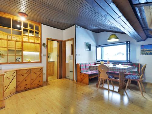 a kitchen and dining room with a table and chairs at Apartment Apt 47 by Interhome in Alba di Canazei