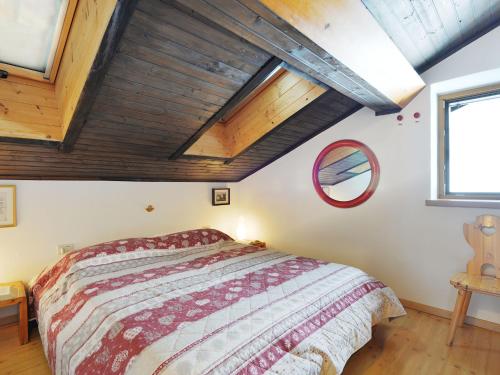 a bedroom with a large bed and wooden ceilings at Apartment Apt 47 by Interhome in Alba di Canazei