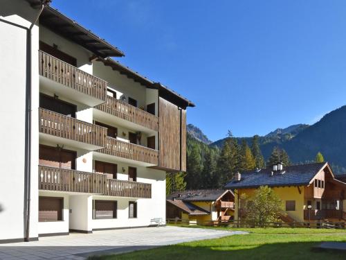 a building with wooden balconies on the side of it at Apartment Des Alpes-8 by Interhome in Canazei