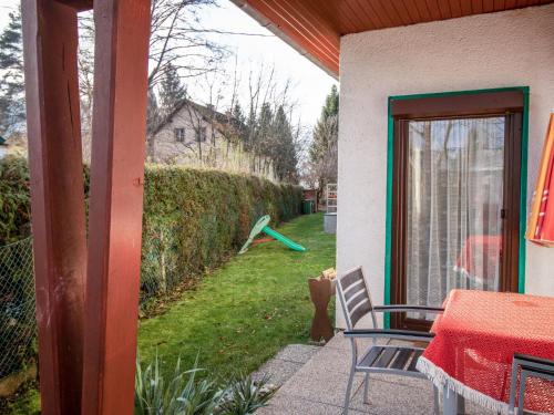 a patio with a sliding glass door and a yard at Holiday Home Laube by Interhome in Sankt Kanzian