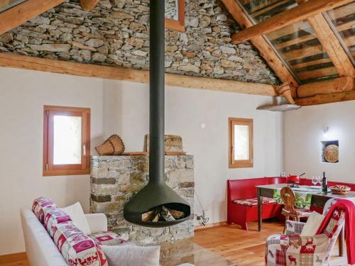 a living room with a stone fireplace in a house at Holiday Home Rustico Andrea by Interhome in Acquarossa