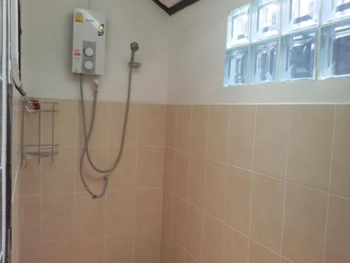 a shower with a shower head in a bathroom at Baitong Homestay in Chiang Mai