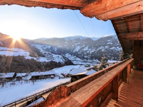 a winter view from the balcony of a log cabin at Apartment Laura by Interhome in Zell am Ziller