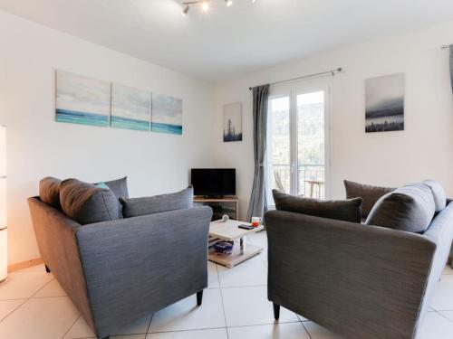 a living room with two couches and a tv at Apartment Les Gentianes by Interhome in Saint-Gervais-les-Bains