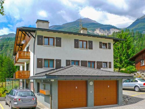 a house with two garage doors in a parking lot at Apartment Fricktalerhuus Apt-1 by Interhome in Surava
