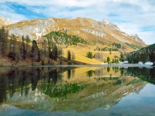 a mountain reflecting in the water of a lake at Apartment Fricktalerhuus Apt-1 by Interhome in Surava