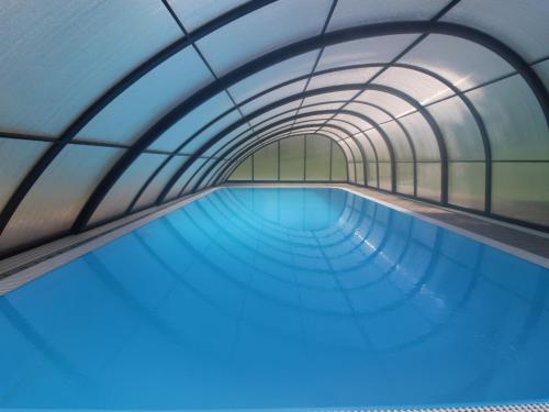 an overhead view of a swimming pool with a tunnel at Holiday Home Holiday Hill 39 by Interhome in Lauterwasser