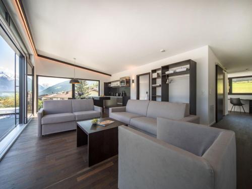 a living room with two couches and a table at Apartment Oberhofer-5 by Interhome in Telfes im Stubai
