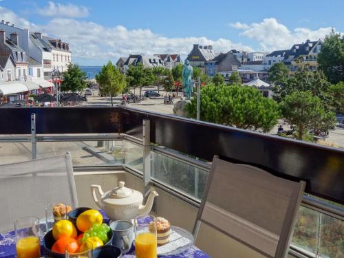 a table with a bowl of fruit on a balcony at Apartment Résidence Le Grand Bleu by Interhome in Quiberon