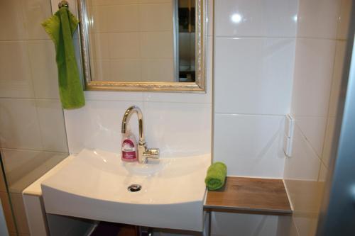 a bathroom with a sink and a mirror and a shower at govienna - City Center Apartments in Vienna