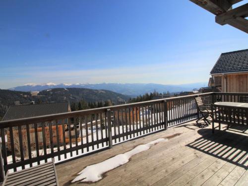 a balcony with a table and a view of mountains at Chalet Klippitzrose by Interhome in Klippitztorl