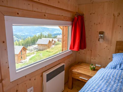 a bedroom with a window and a bed and a desk at Chalet Klippitzrose by Interhome in Klippitztorl
