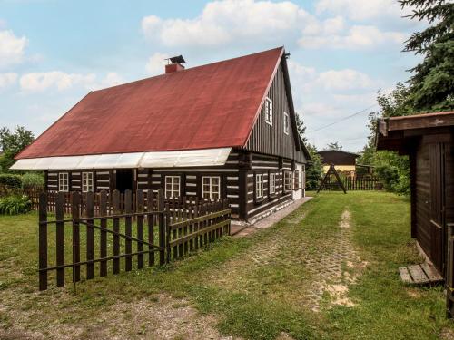 an old black barn with a red roof at Holiday Home Lánov by Interhome in Horní Lánov