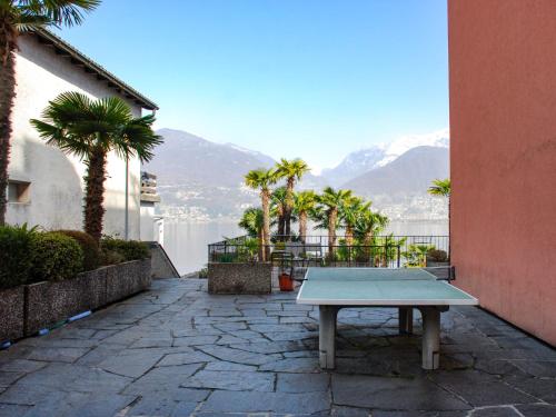 a ping pong table on a patio with a view of the water at Apartment App- Vira Lago 500 Ost - EG by Interhome in Vira