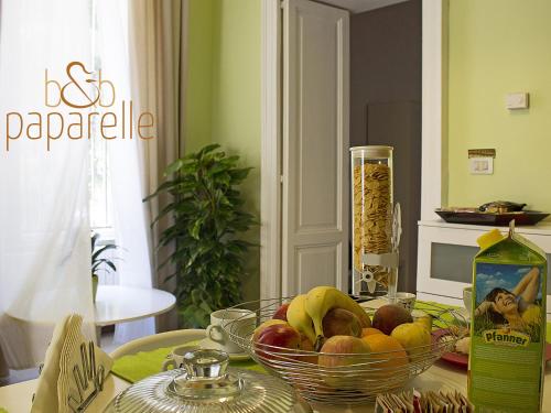 a bowl of fruit on a table in a kitchen at B&B Paparelle in Cosenza