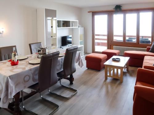 a living room with a table and chairs and a couch at Apartment Derborence 28 by Interhome in Nendaz