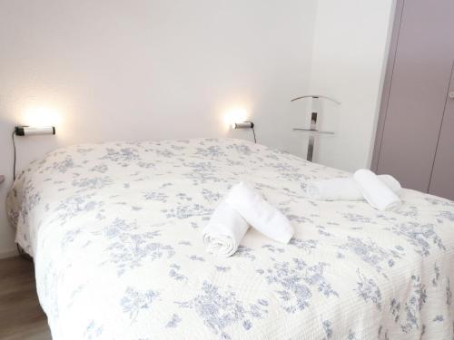 a bedroom with a bed with towels on it at Apartment Derborence 28 by Interhome in Nendaz