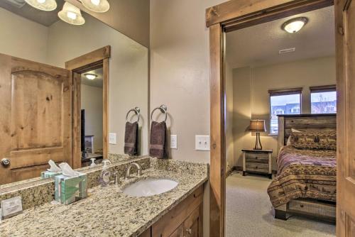 a bathroom with a sink and a bed and a mirror at Chic Eden Condo with Balcony and Updated Interior in Eden