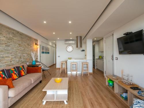 een woonkamer met een bank en een tafel bij Apartment Apartment S'Illot-Cala Morlanda by Interhome in S'Illot