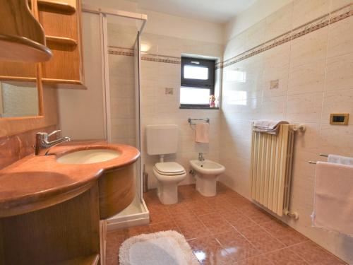 a bathroom with a sink and a toilet and a window at Apartment Grosio Terrace by Interhome in Grosio