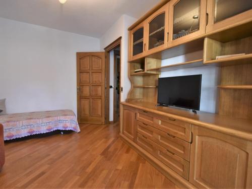 a living room with a tv on a wooden dresser at Apartment Grosio Terrace by Interhome in Grosio
