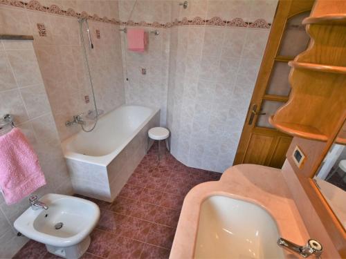 a bathroom with a tub and a sink and a toilet at Apartment Grosio Terrace by Interhome in Grosio