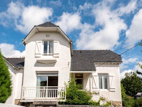 a white house with a black roof at Holiday Home Rayon de soleil by Interhome in Carnac