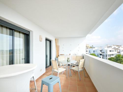 een wit appartement met een balkon met een tafel en stoelen bij Apartment Alamar by Interhome in Mijas Costa