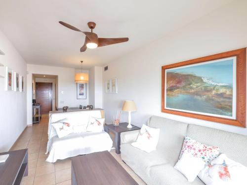 a living room with a couch and a ceiling fan at Apartment Alamar by Interhome in Mijas Costa