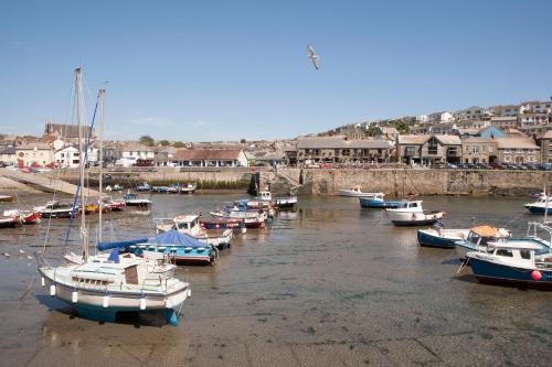 a group of boats are docked in a harbor at Harbour Inn in Porthleven