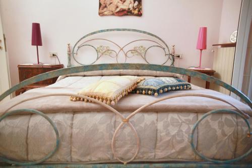 a bed with a metal frame in a bedroom at Villa Cecilia Bed and Breakfast in Cellole