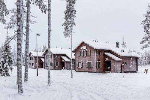 a log cabin in the snow with trees at Ranua Resort Holiday Villas in Ranua