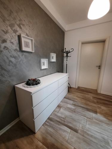 a room with a white dresser and a wall at Apartman 57 in Vračar (historical)