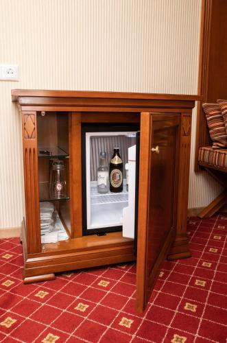 an open cabinet with a bottle of beer in it at Hotel Gasthof Post in Nesselwang