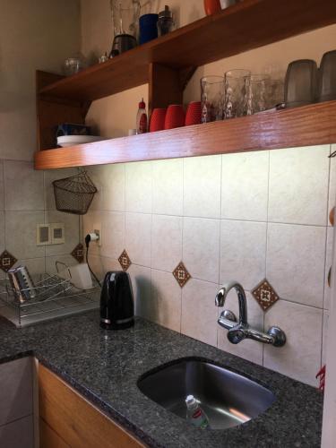 a kitchen with a sink and a counter top at Casa Bacana in Punta Del Diablo