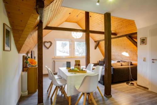 a living room with a white table and chairs at Haus Schulze in Braunlage