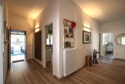 a room with a hallway with wooden floors and a door at Ca Belee by Halldis in Vercana
