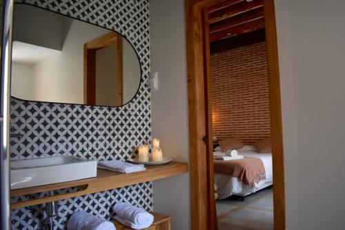 a bathroom with a mirror and a sink and a bed at Casa Rural de Ancos, Guadamur, Toledo in Guadamur
