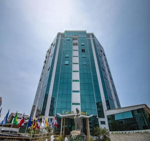 a tall building with a statue in front of it at Miraflores Colon Hotel in Lima