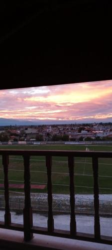a view of a field from a balcony at sunset at oniron in Sidhirókastron