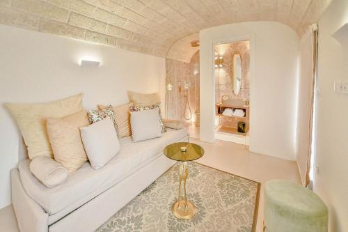 a living room with a couch and a table at Eurydice Suite with Infinity Jacuzzi in Ostuni
